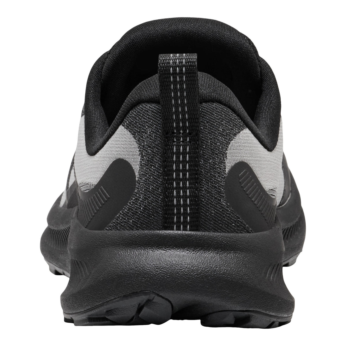 A close-up rear view of a black and gray athletic shoe, showing the heel counter, pull tab, textured knit upper, and thick black midsole on a white background.