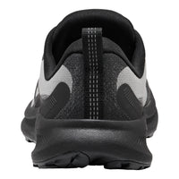 A close-up rear view of a black and gray athletic shoe, showing the heel counter, pull tab, textured knit upper, and thick black midsole on a white background.