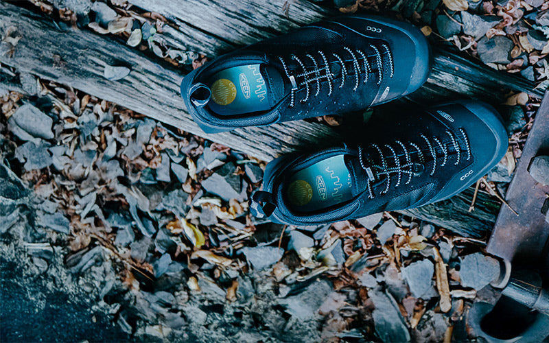 Black shoes on a rocky surface