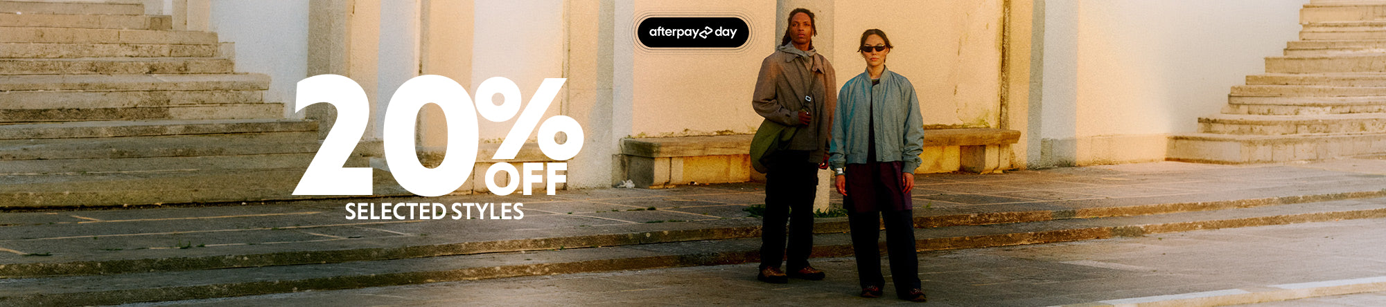 A promotional banner featuring two models standing on stone steps in front of a building, with large text reading '20% OFF SELECTED STYLES' and a small 'otherwise.com' logo above.