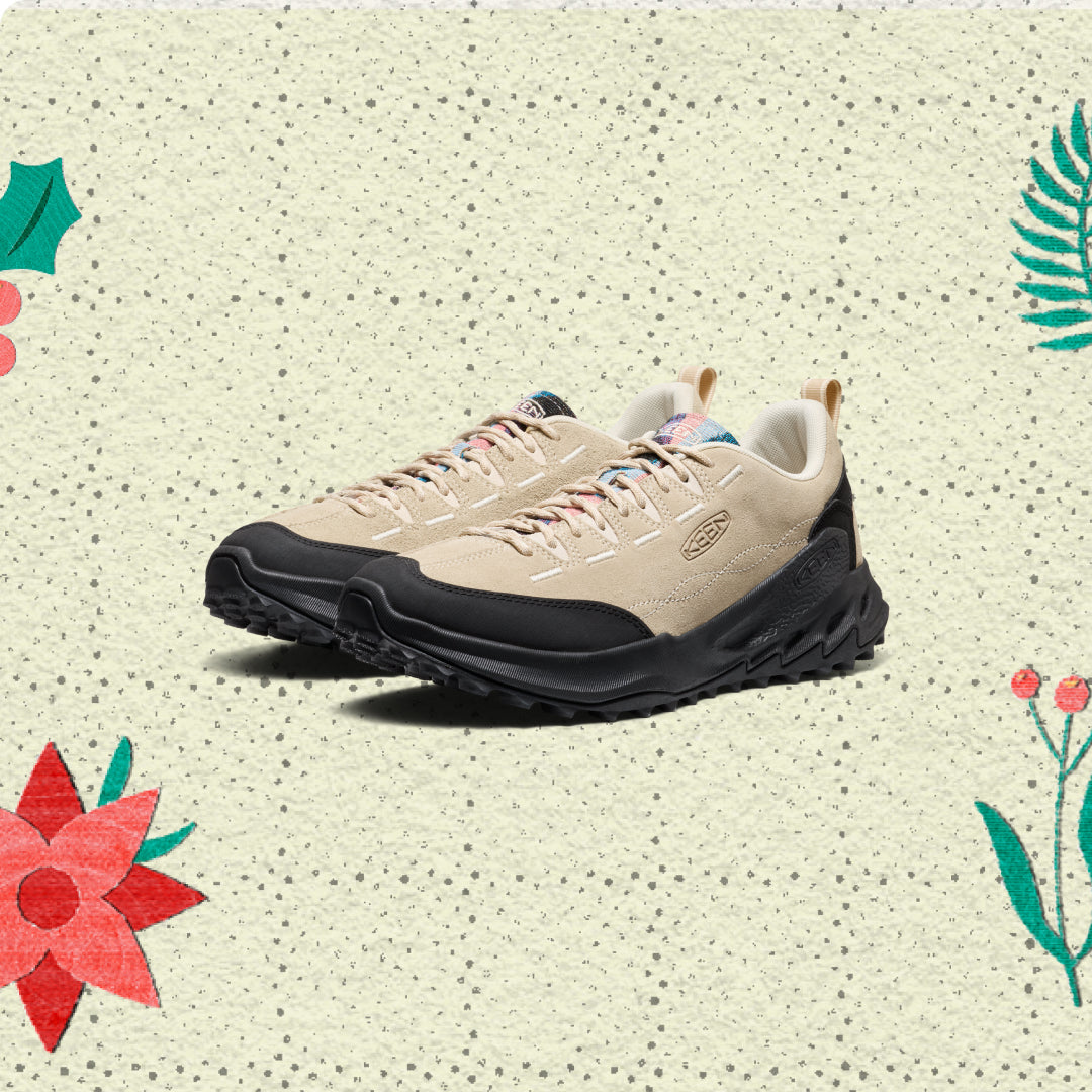 Beige sneaker with black sole on a patterned background