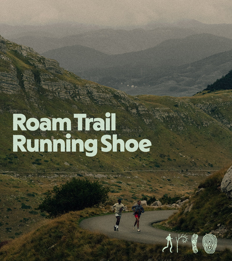 Two people running on a trail with mountains in the background, featuring 'Roam Trail Running Shoe' text.